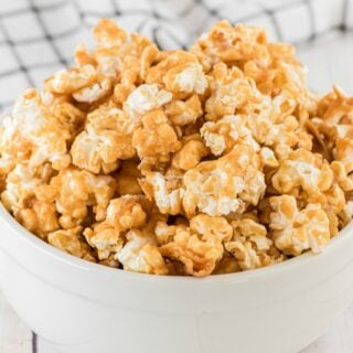 Caramel corn in white bowl.