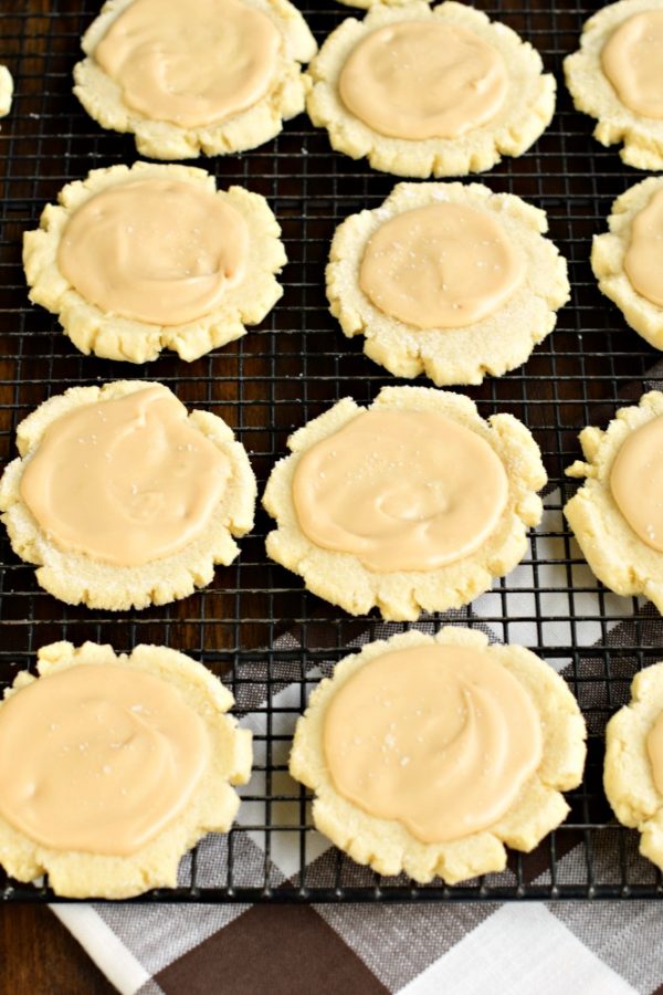 These Caramel Frosted Sugar Cookies are irresistible. Chewy sugar cookies with a no-chill dough topped with a sweet and salty caramel frosting!