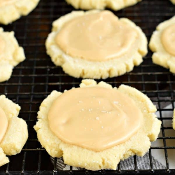 These Caramel Frosted Sugar Cookies are irresistible. Chewy sugar cookies with a no-chill dough topped with a sweet and salty caramel frosting!