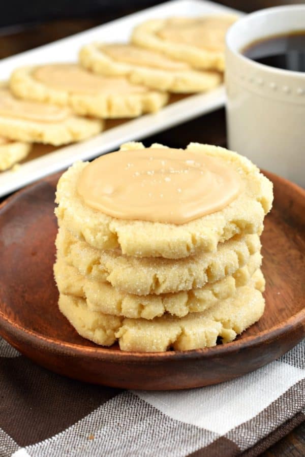 These Caramel Frosted Sugar Cookies are irresistible. Chewy sugar cookies with a no-chill dough topped with a sweet and salty caramel frosting! #sugarcookies