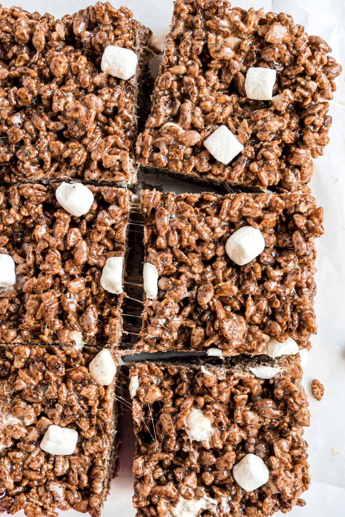 Chocolate rice krispie treats cut into large squares.