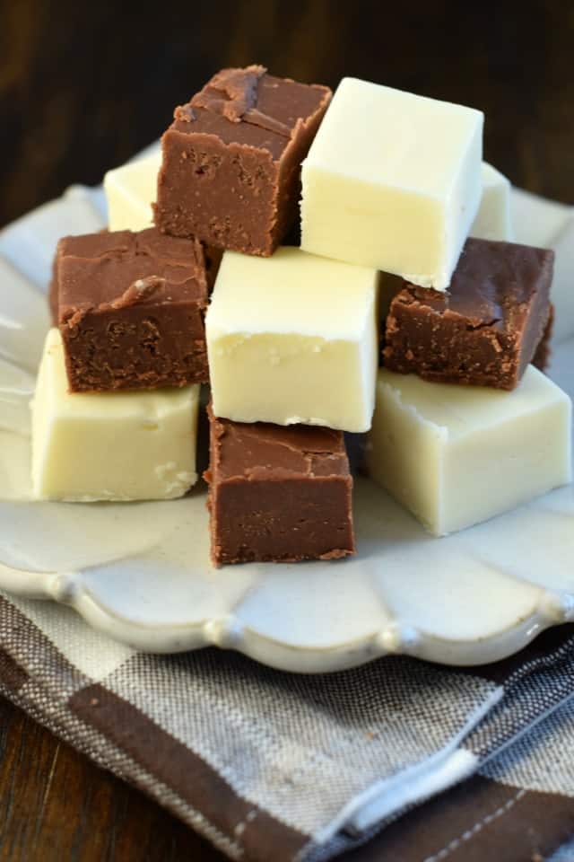 Want to be the hit of every party? Learn How to Make Chocolate Fudge! It really is easier than you think and is a snap to customize with your favorite flavors and mix-ins –it’ll make you the star of every dessert table! Plate with pieces of chocolate and vanilla fudge.