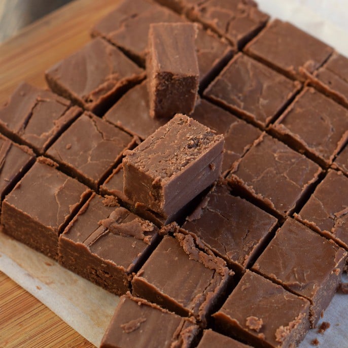 Cutting board with pieces of chocolate fudge.