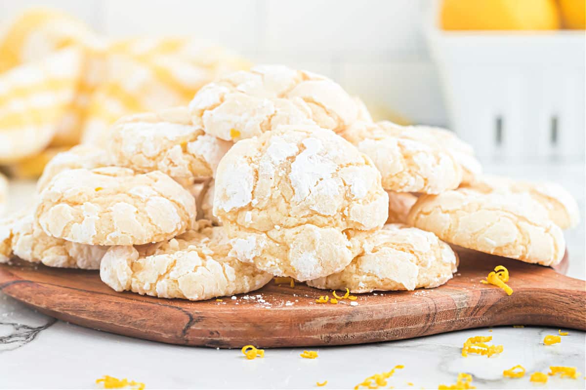 Lemon gooey cookies on a wooden cutting board.