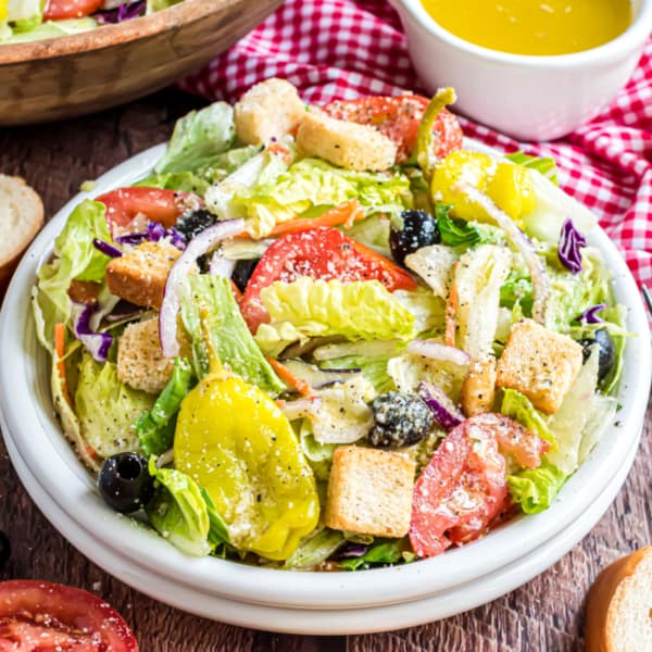 This speedy Copycat Olive Garden salad recipe is loaded with fresh flavor and your new favorite dressing! We'll use my secret ingredient to make it perfectly creamy and zesty. This simple side is a quick and healthy pairing for any weeknight meal.