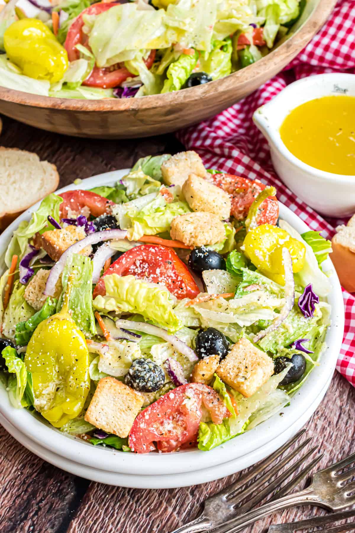 Homemade olive garden salad served in a white bowl.