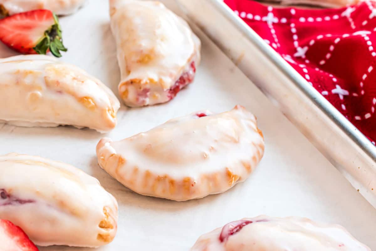 Strawberry Hand Pies are the perfect sweet treat to share with family and friends. This recipe is so easy, you'll want to make a double batch. We shaped some of them heart shaped, for Valentine's Day.