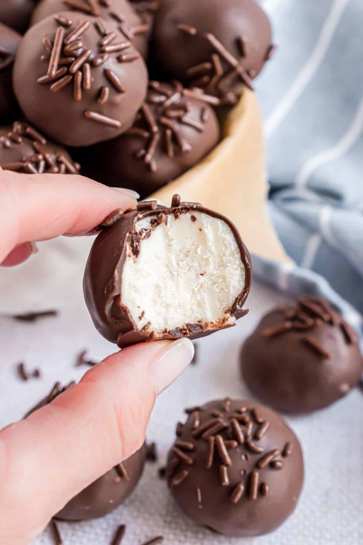 Buttercream chocolate truffle with a bite taken out.