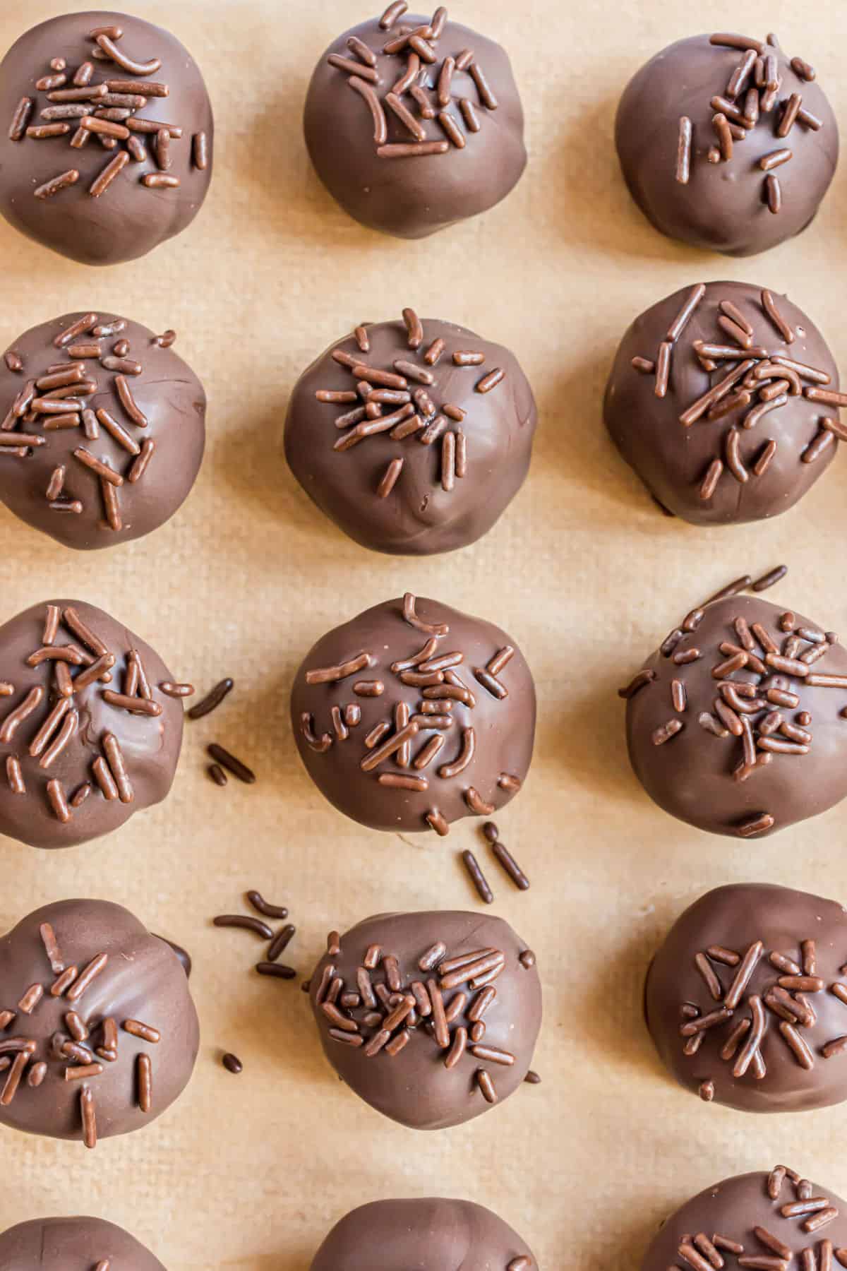 Buttercream truffles on parchment paper.