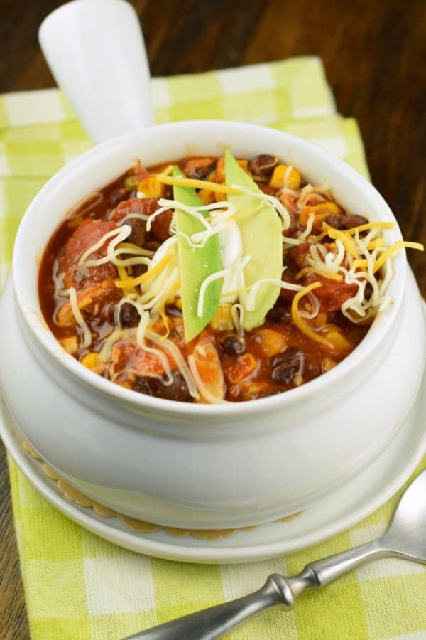 Hearty and flavorful, this fix it and forget it Slow Cooker Chicken Enchilada Chili recipe is delicious!