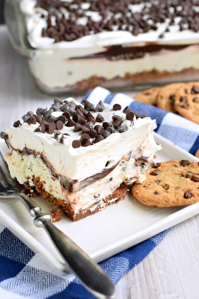 Slice of chocolate chip cookie lasagna on a white plate.