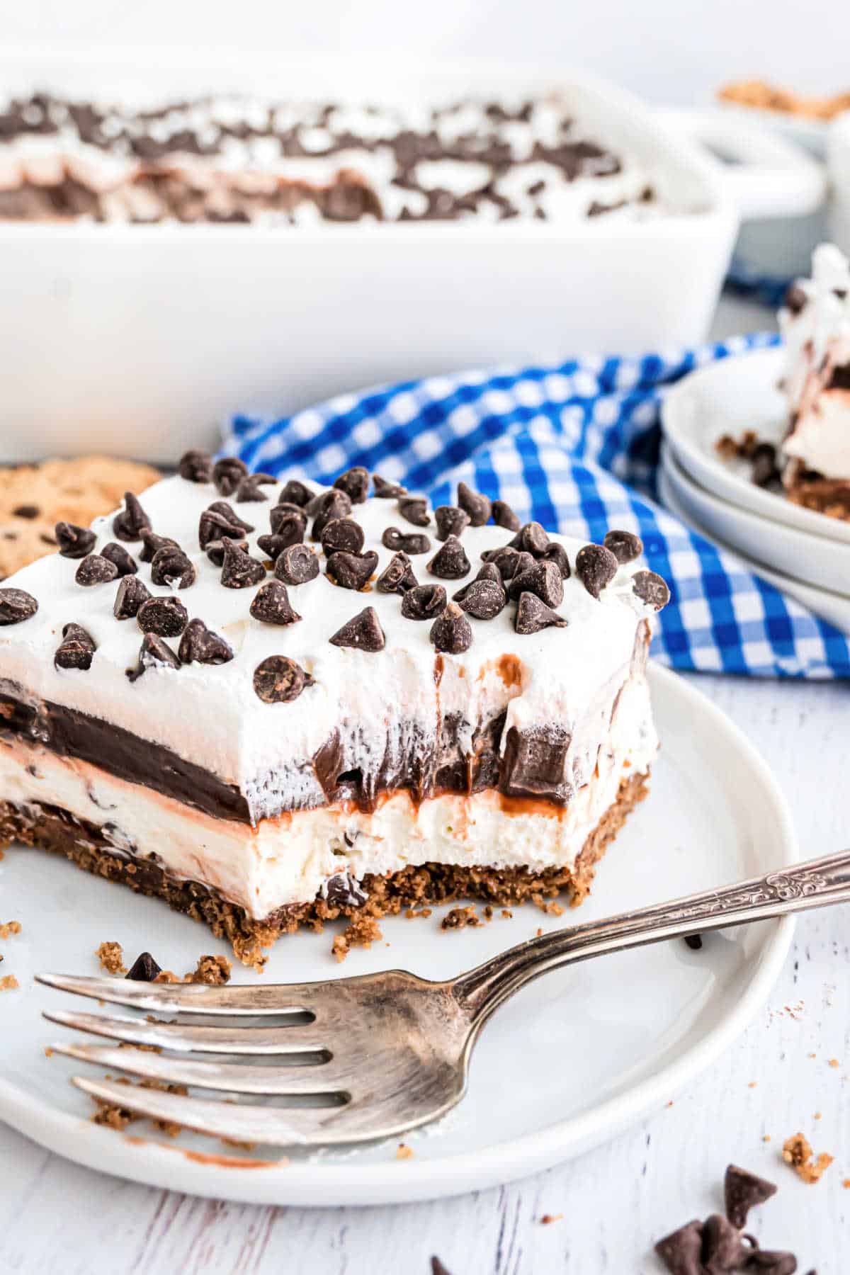 Slice of layered cookie lasagna with a bite taken out.