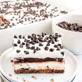 My No Bake Chocolate Chip Cookie Lasagna has layers of chocolate chip cookies, creamy cheesecake, fudge pudding, and whipped cream! Perfect for any party!