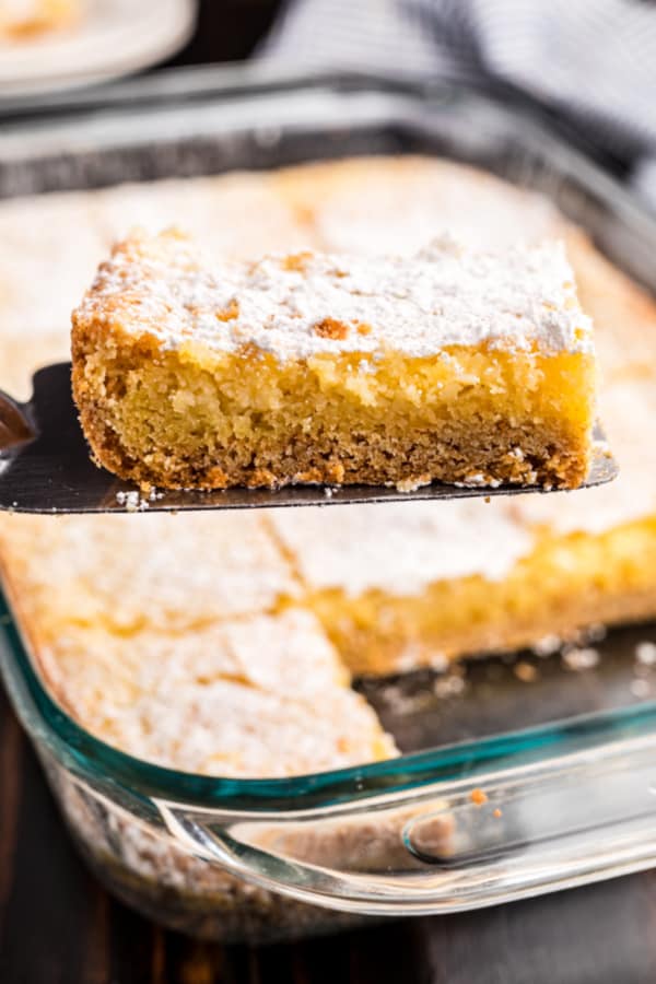 Gooey butter cake slice on spatula.