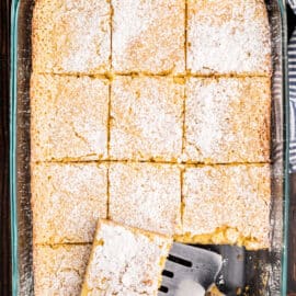 13x9 baking dish with gooey butter cake slices.