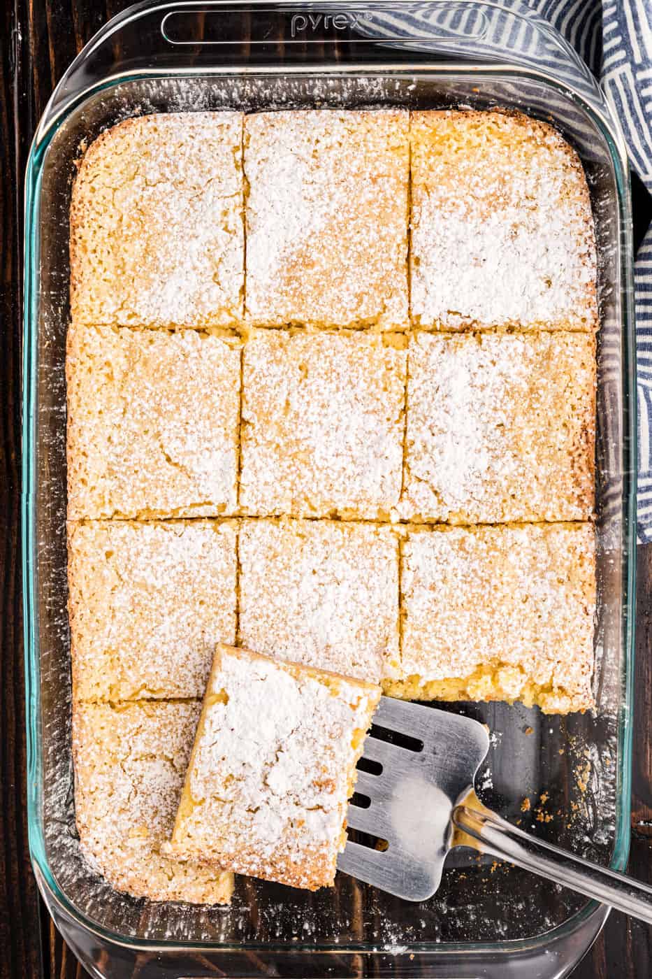 13x9 baking dish with gooey butter cake slices.