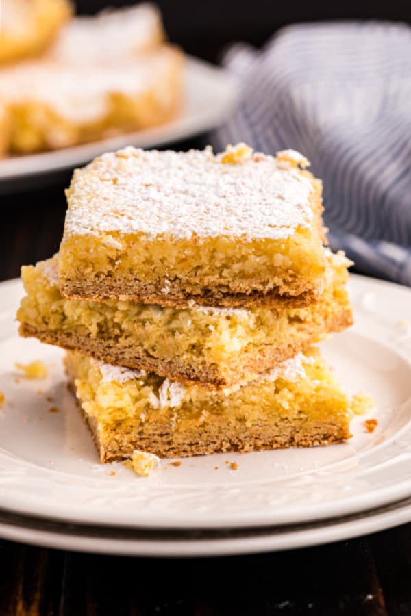 Gooey butter cake slices stacked on top of each other.