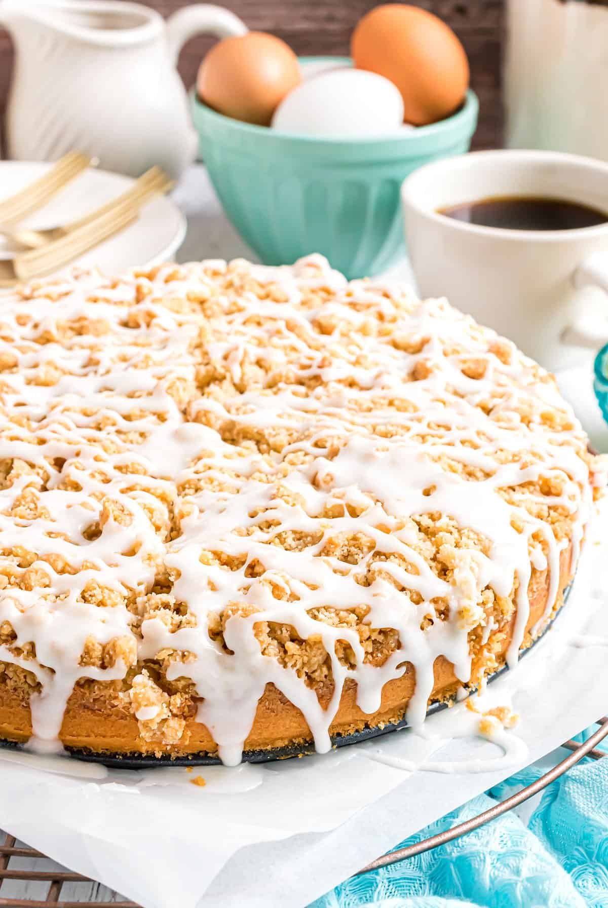 Lemon coffee cake on parchment paper lined plate.