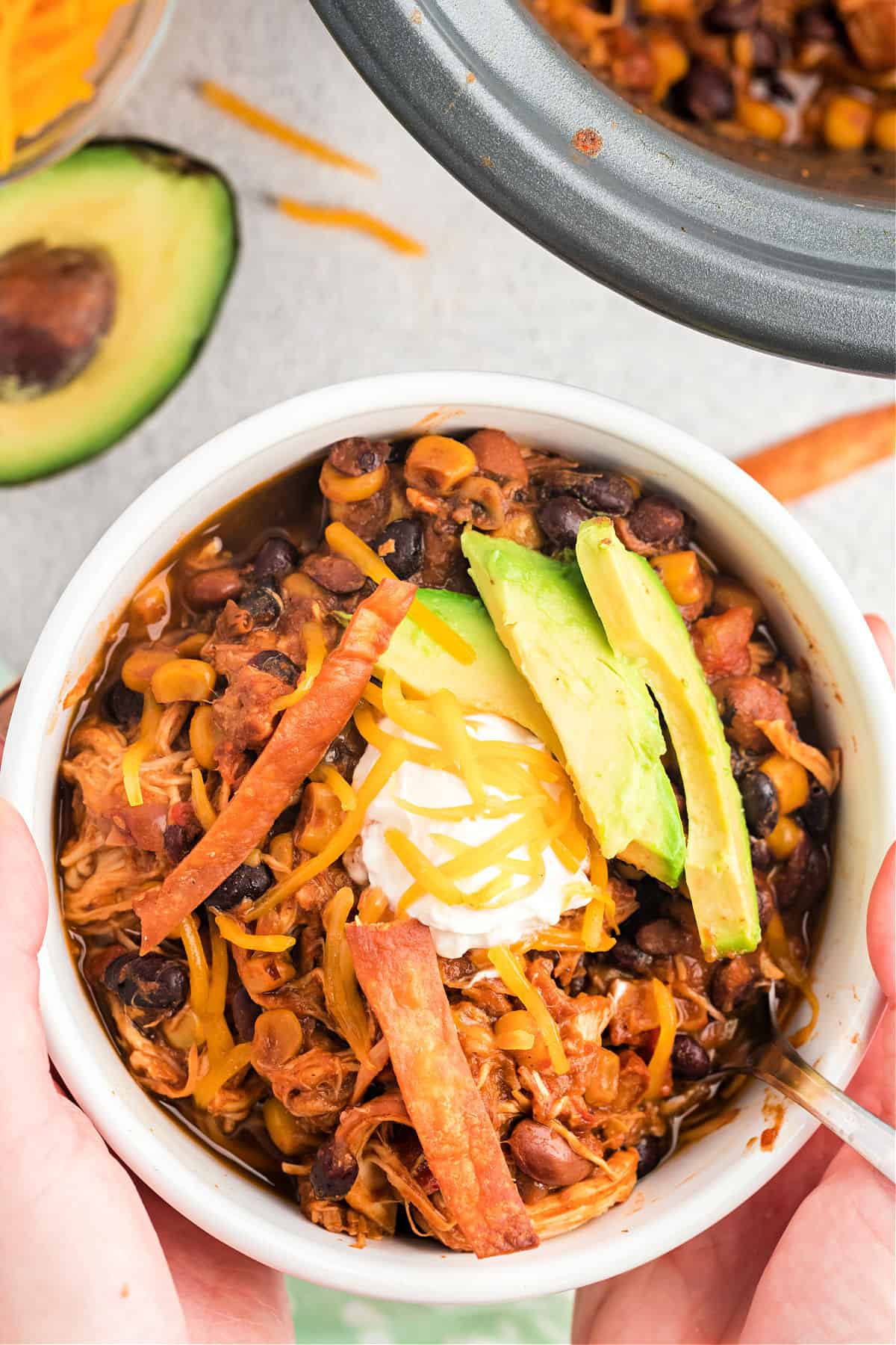 Chicken chili served in a white bowl.