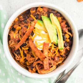 This Slow Cooker Chicken Enchilada Chili recipe is full of hearty, warming flavors. Best of all, it takes almost no effort to make. Just fix it and forget it!