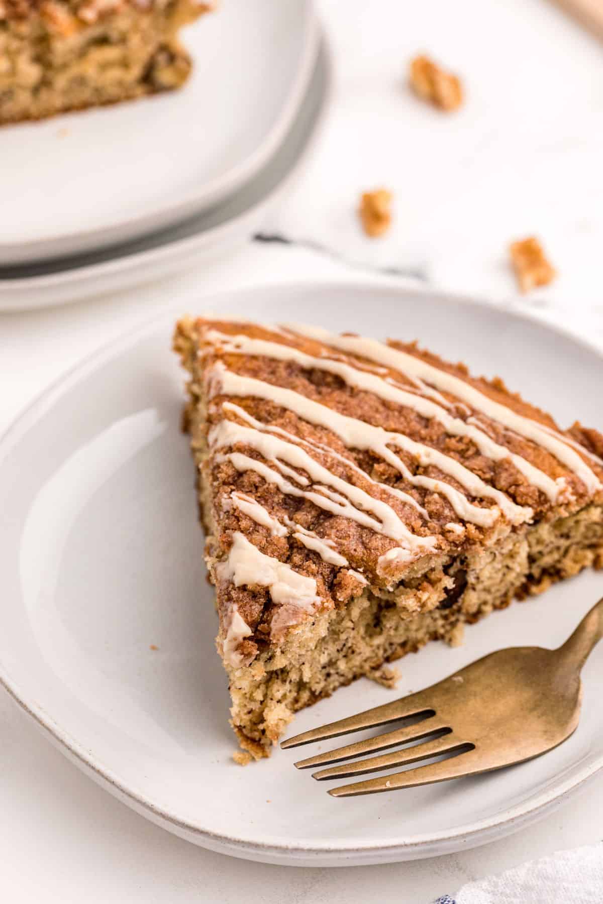 Slice of banana coffee cake on a white plate.