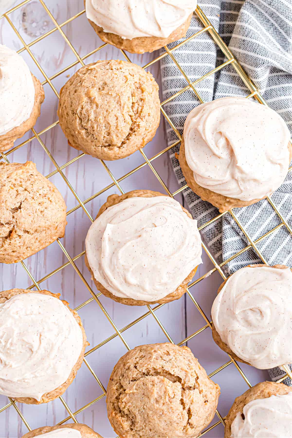 Banana cookies with frosting on a cooling rack.
