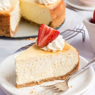 Slice of cheesecake on a white plate.