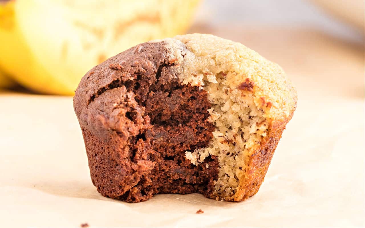 Chocolate banana muffins with a bite taken out.