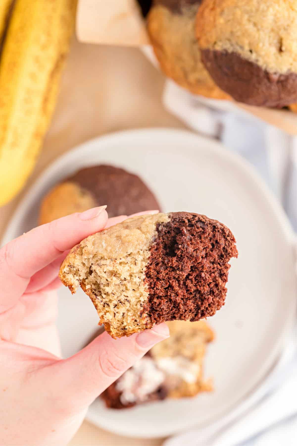 Banana muffins with chocolate and a bite taken out.