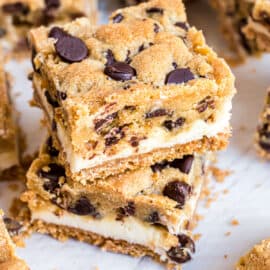 Chocolate Chip Cheesecake Bars with a graham cracker base, creamy cheesecake filling and delicious chocolate chip cookie crunch. These cold cookie bars are a perfect make ahead dessert!