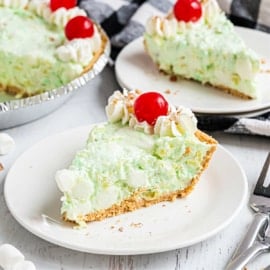 Slice of pistachio pie on a white plate.