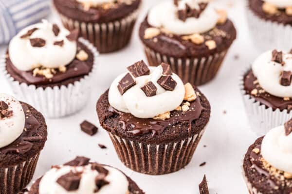 Chocolate s'mores cupcakes on marble counter.