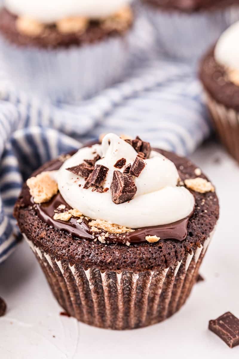 Chocolate cupcake topped with ganache, marshmallow frosting and graham cracker crumbs.