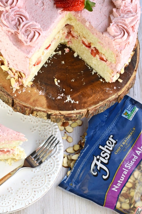 This gorgeous, from scratch, Strawberry Almond Cake recipe features a moist almond layer cake with strawberry buttercream. Fresh sliced almonds and strawberries to added flavor and texture!