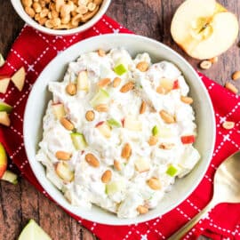 Treat your dinner guests or potluck friends and family to an Easy Taffy Apple Salad recipe. Made with apples, pineapple, whipped cream, peanuts & more. 