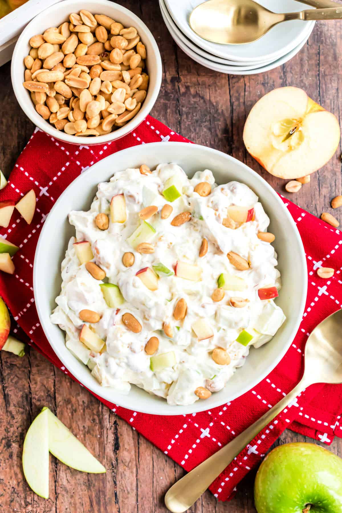 Cool whip apple salad in a white bowl with red linen.