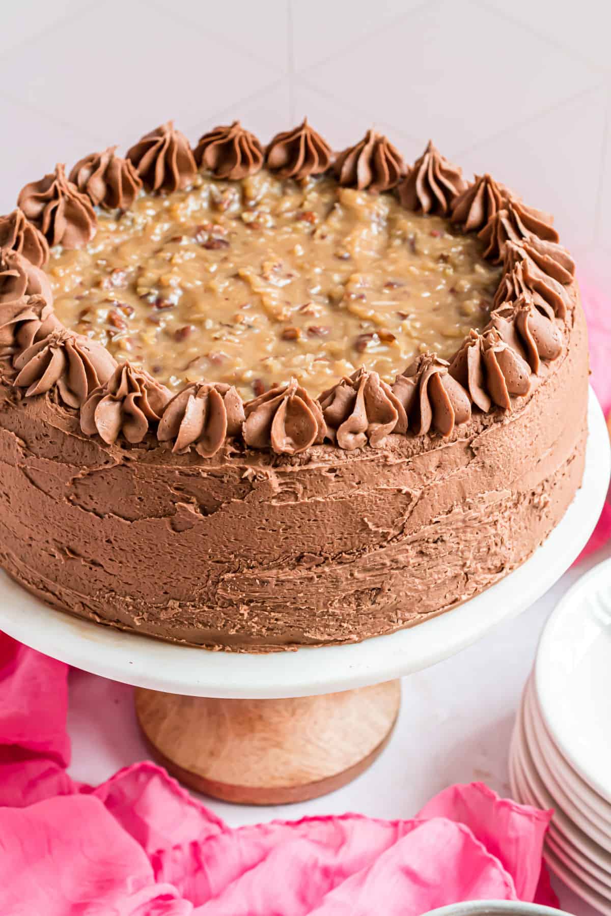 German chocolate cake on a white cake platter.