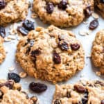 Oatmeal raisin cookies on parchment paper.