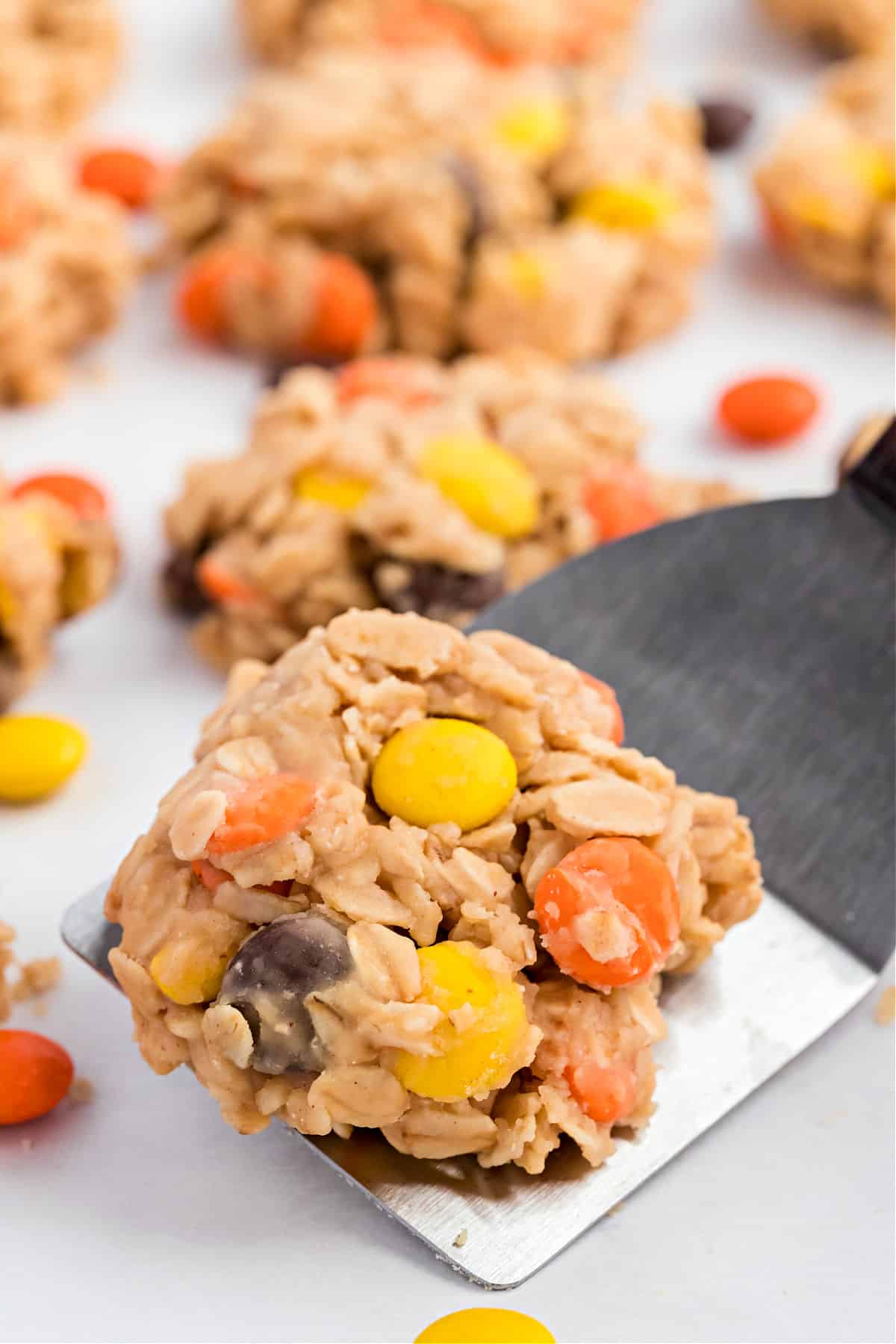 No bake cookies with reeses pieces on parchment paper.