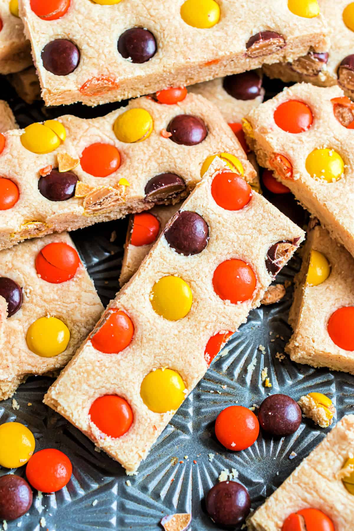 Peanut butter and reese's shortbread bars on a metal baking sheet.