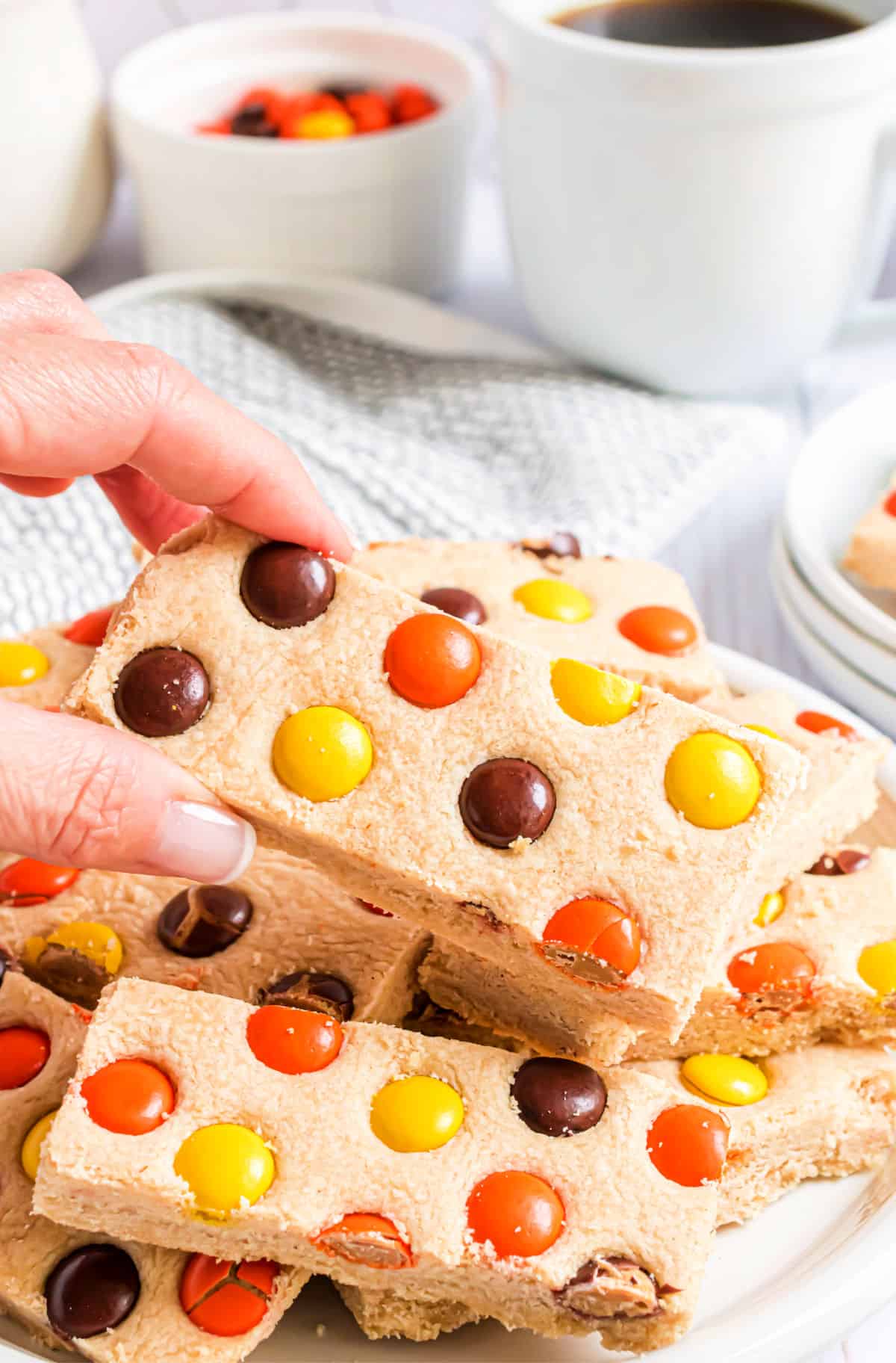 Shortbread bars with Reese's pieces on a serving plate.