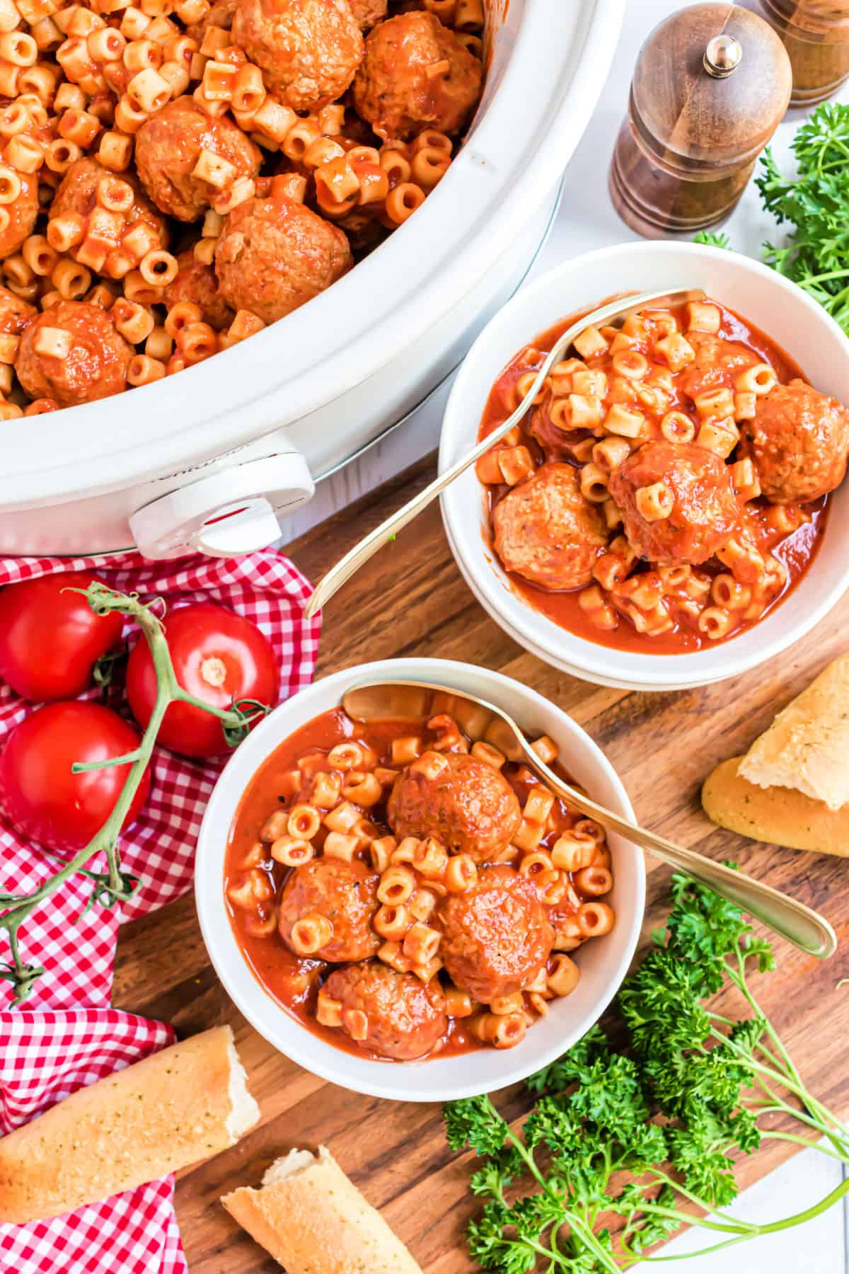 Spaghettios and meatballs served in a white bowls.