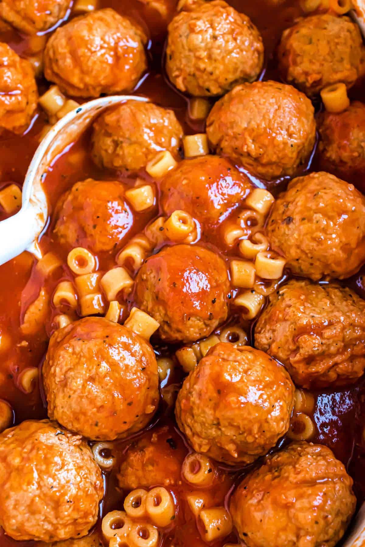 Spaghettios and meatballs with a spoon.