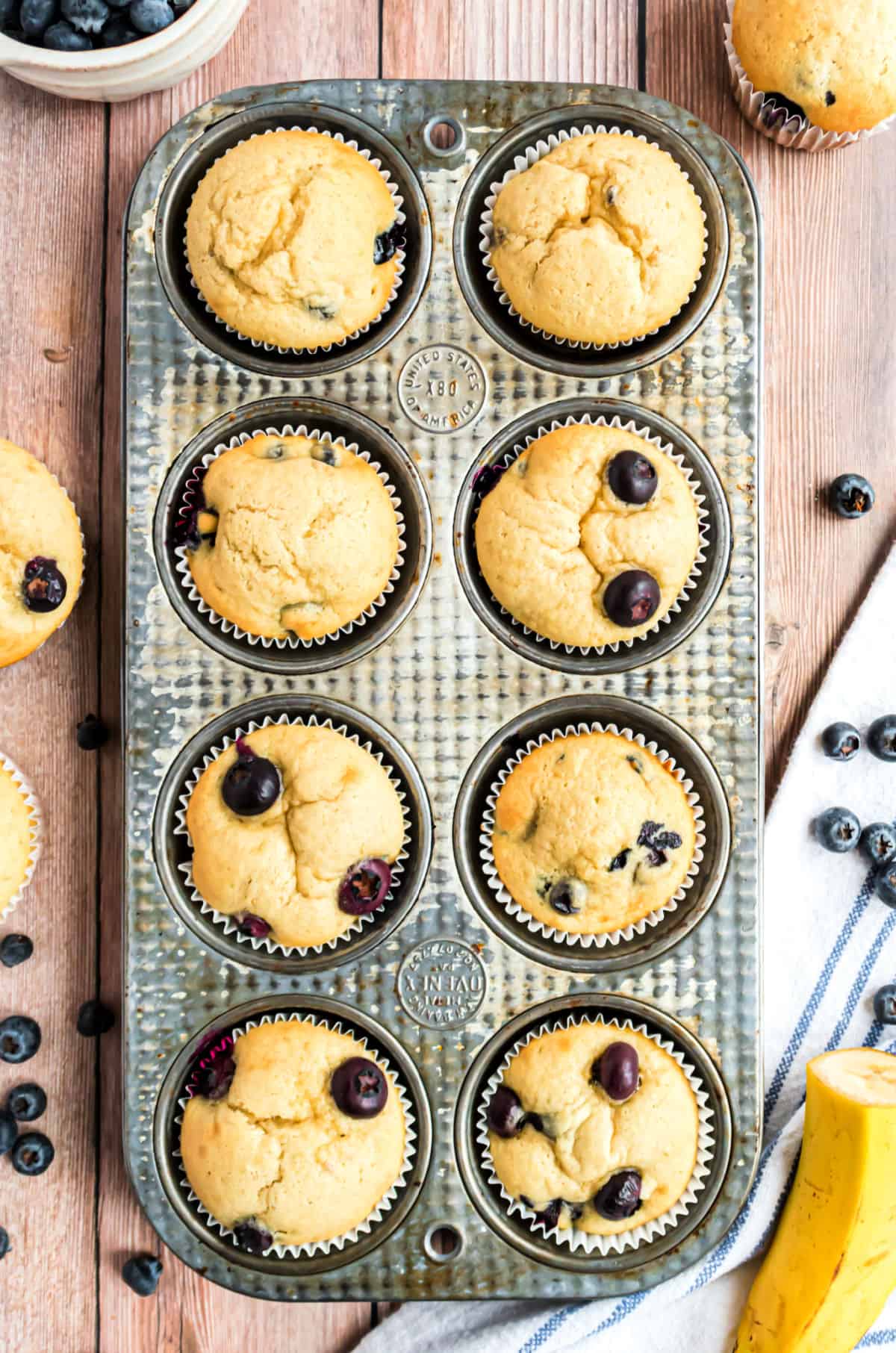 Blueberry banana muffins in a metal muffin tin.