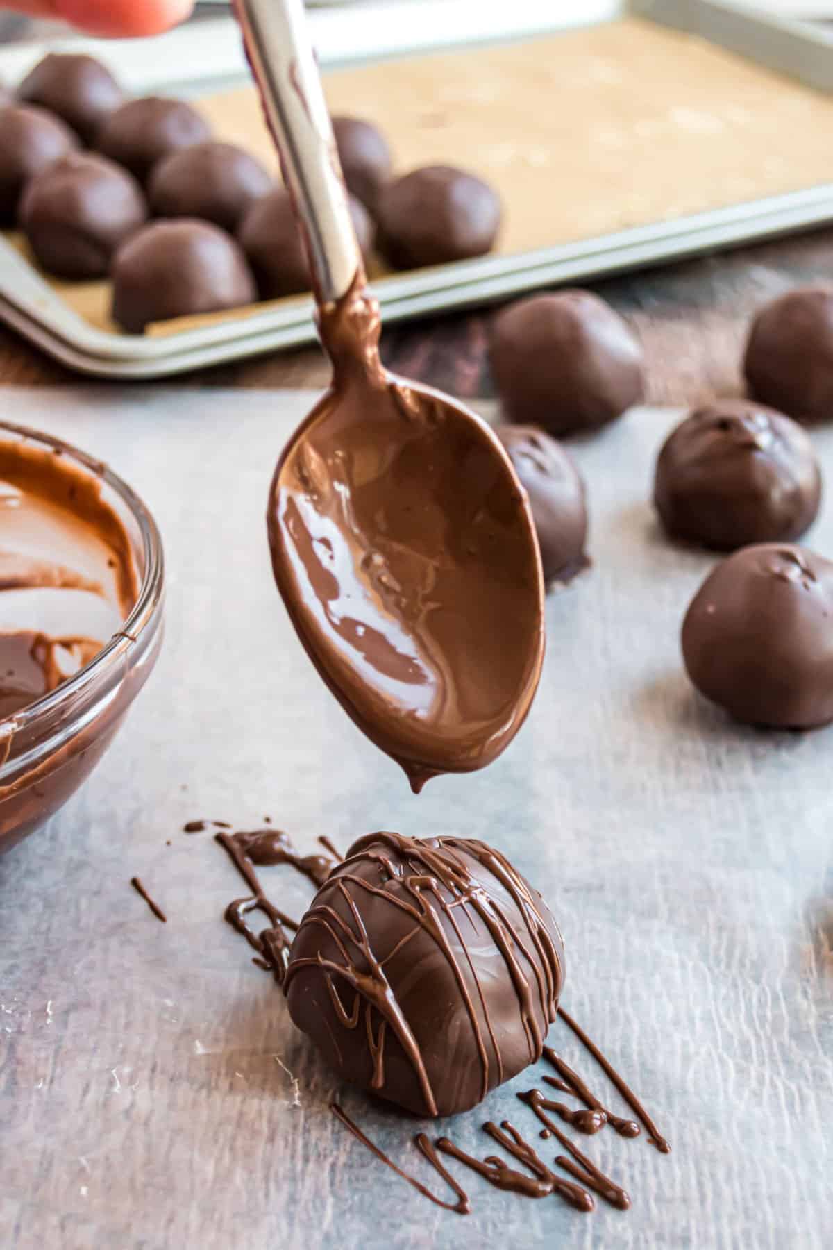 Melted chocolate drizzled on cookie dough truffle.