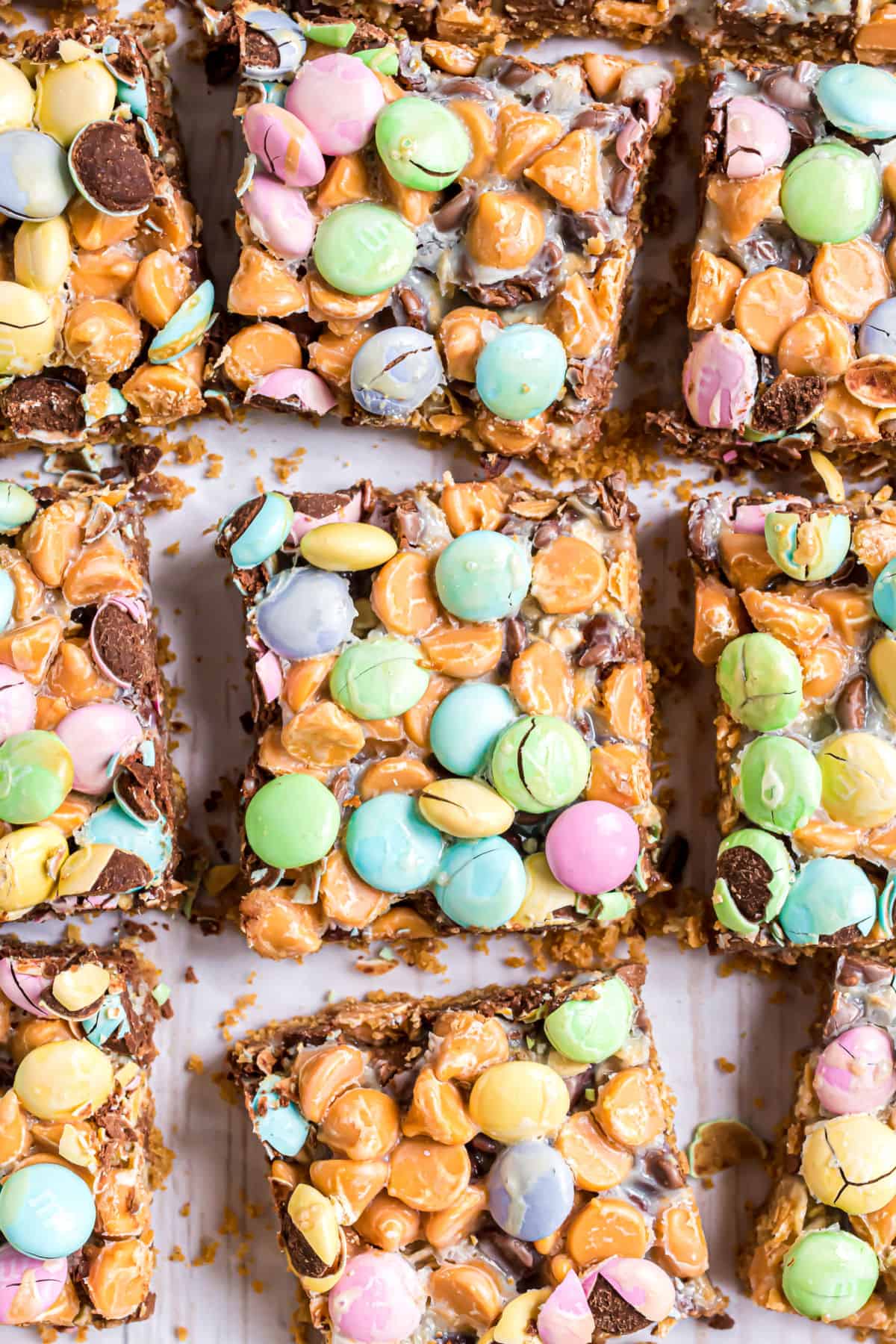 Magic cookie bars with butterscotch and M&M's cut into bars.