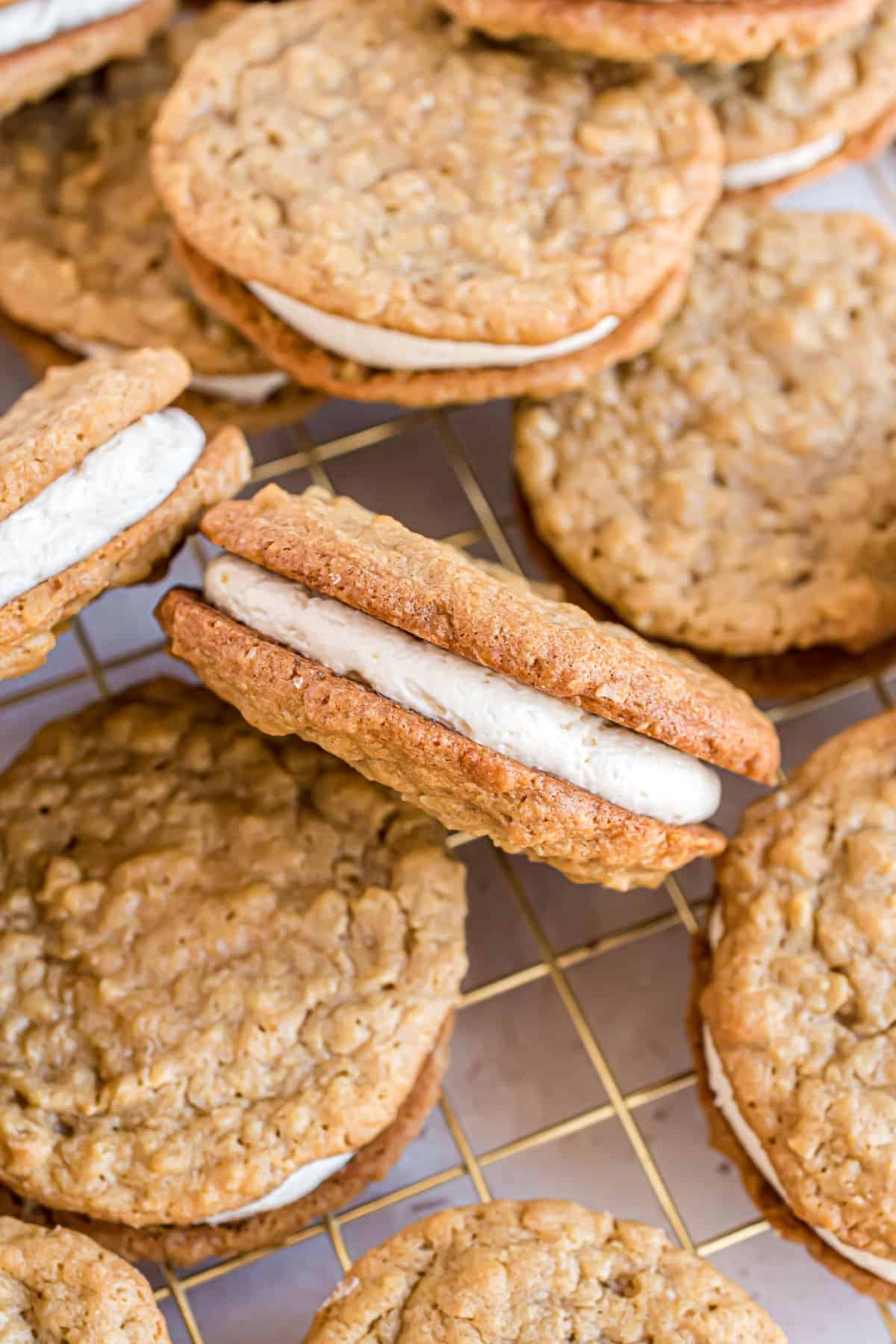 Oatmeal Cream Pies stacked on a wire cooling rack.