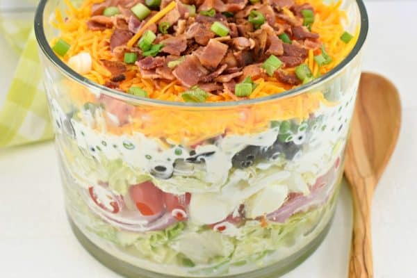 A classic, easy 7 layer Salad recipe served in a trifle bowl. So many options for the seven layers, you choose what you love. Perfect for potlucks!