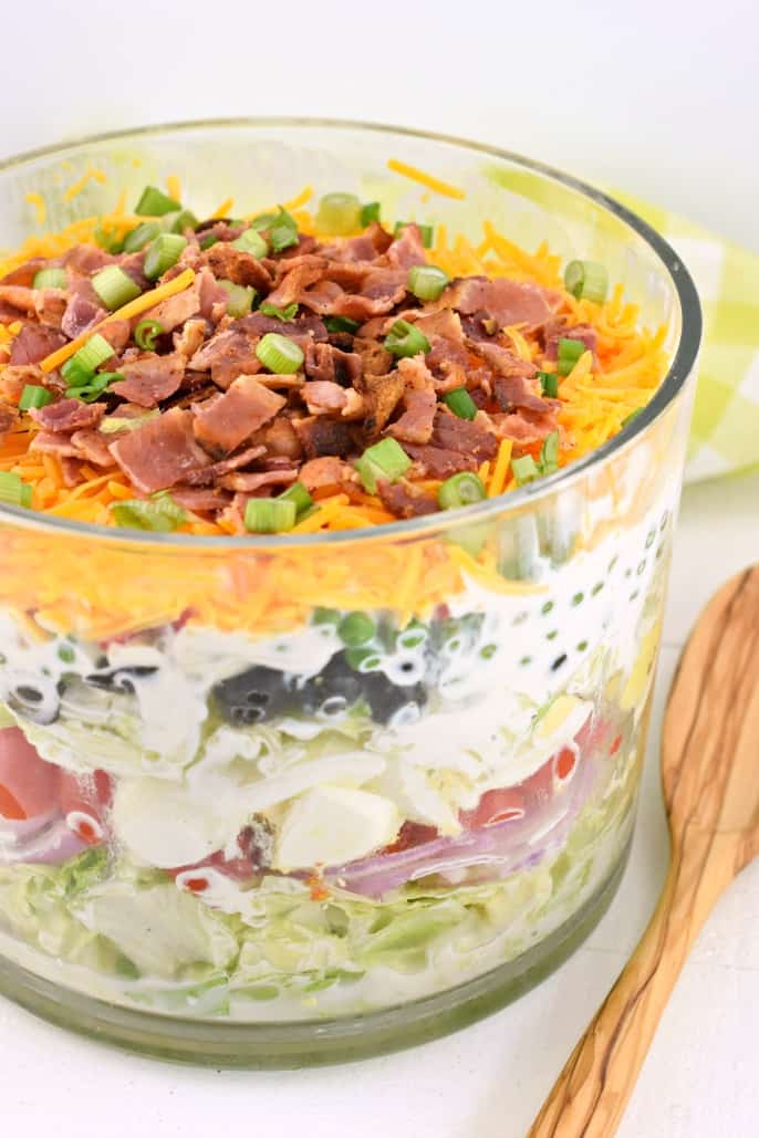 Layered salad in a trifle bowl.