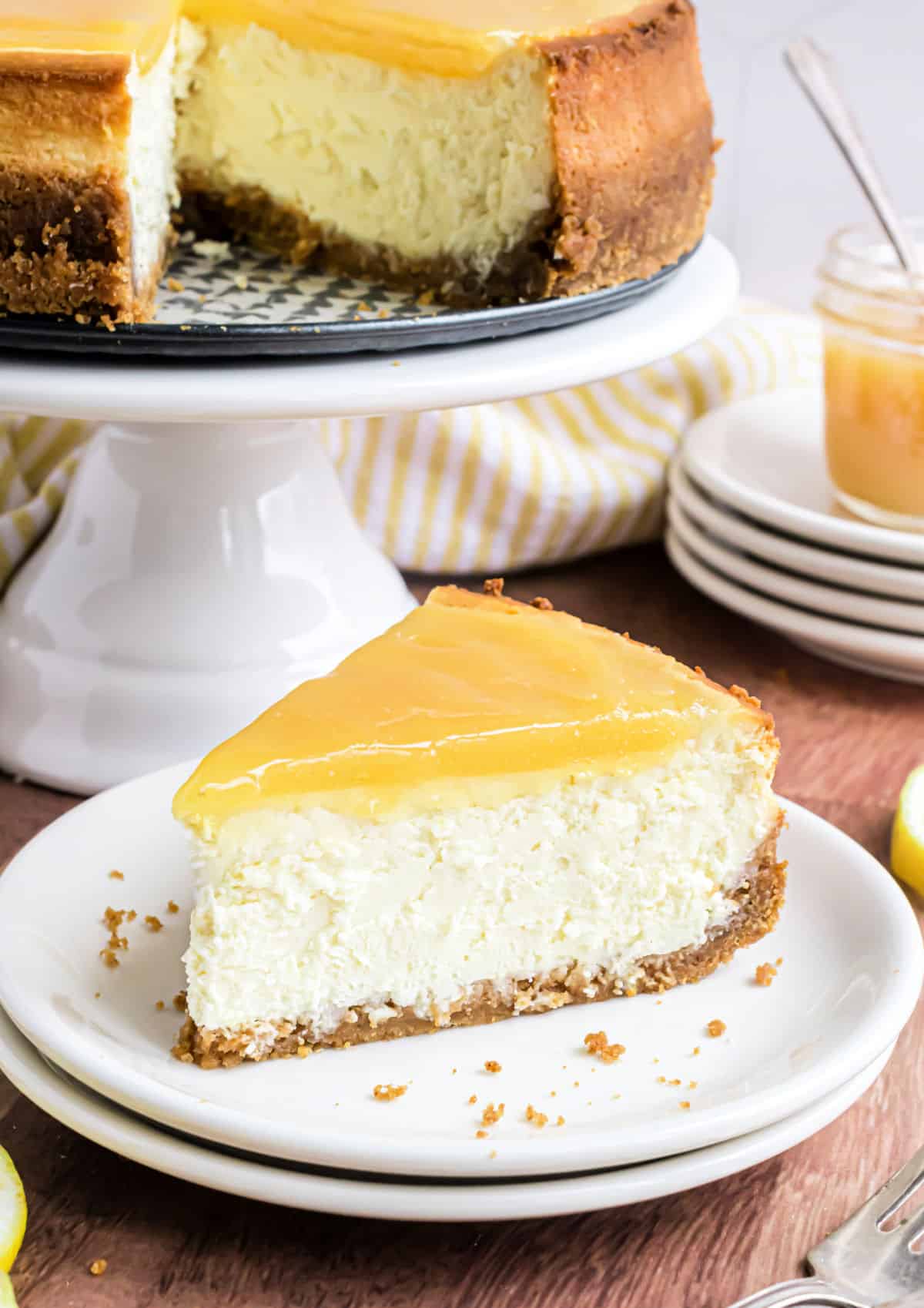 Slice of lemon cheesecake on a white plate.